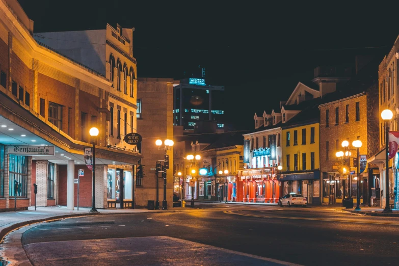 a town at night with some buildings lit up