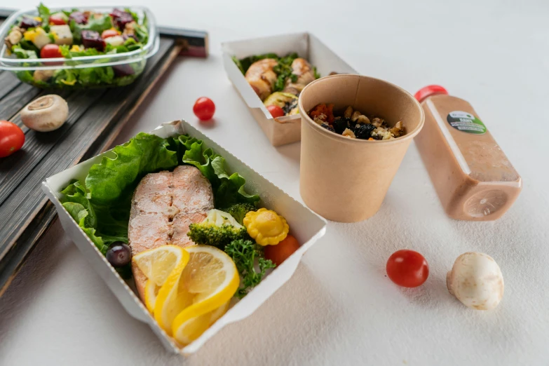 a close up of a tray of food on a table, a picture, cardboard, salad, set against a white background, thumbnail