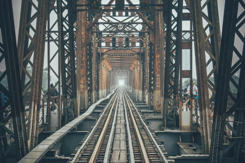 old train tracks are crossing into an old, rusty looking building