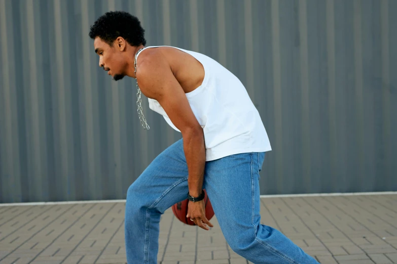 a man with his foot on an orange ball