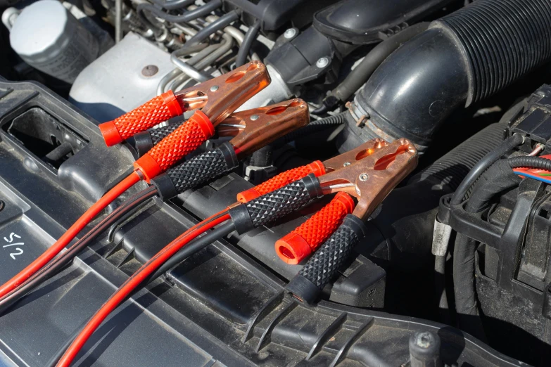 two jumpers plugged into a car's engine, by Julian Allen, shutterstock, black steel with red trim, copper wire, 15081959 21121991 01012000 4k, lightweight