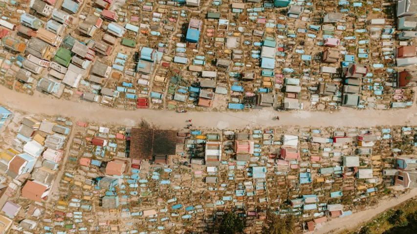 a bird's eye view of a city from a bird's eye view, an album cover, trending on unsplash, conceptual art, burnt huts, in the middle of a graveyard, somalia, vehicle