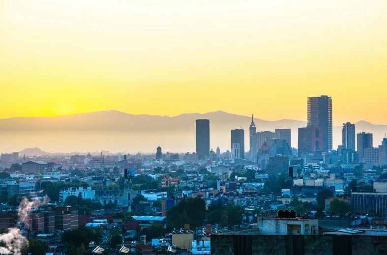 a view of a city from a high rise building, pexels contest winner, mexican folklore, sun at dawn, slide show, an ancient