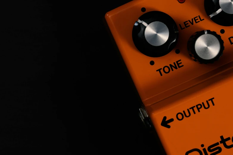 an orange pedal sitting on top of a black table, by Doug Ohlson, trending on pexels, bass sound waves on circuitry, octane], ochre, thumbnail