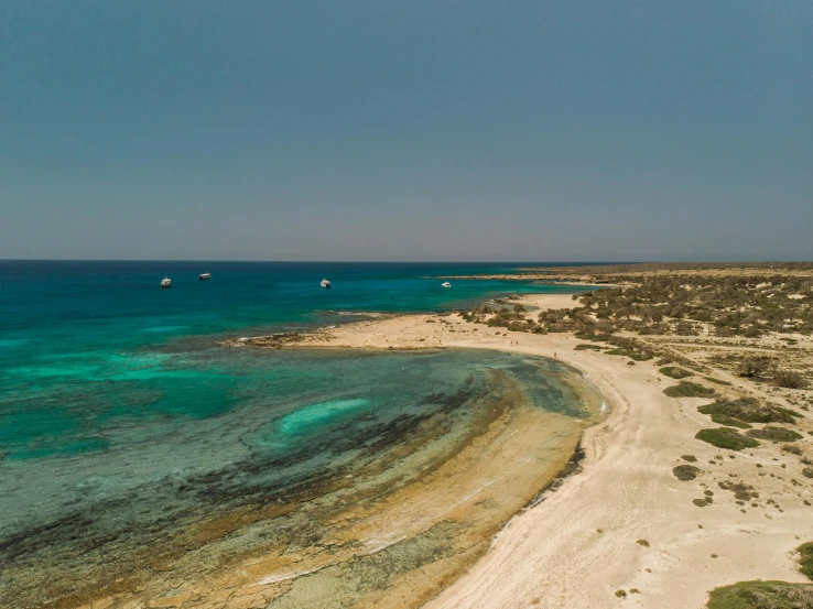 boats moored in the turquoise clear water of a beach