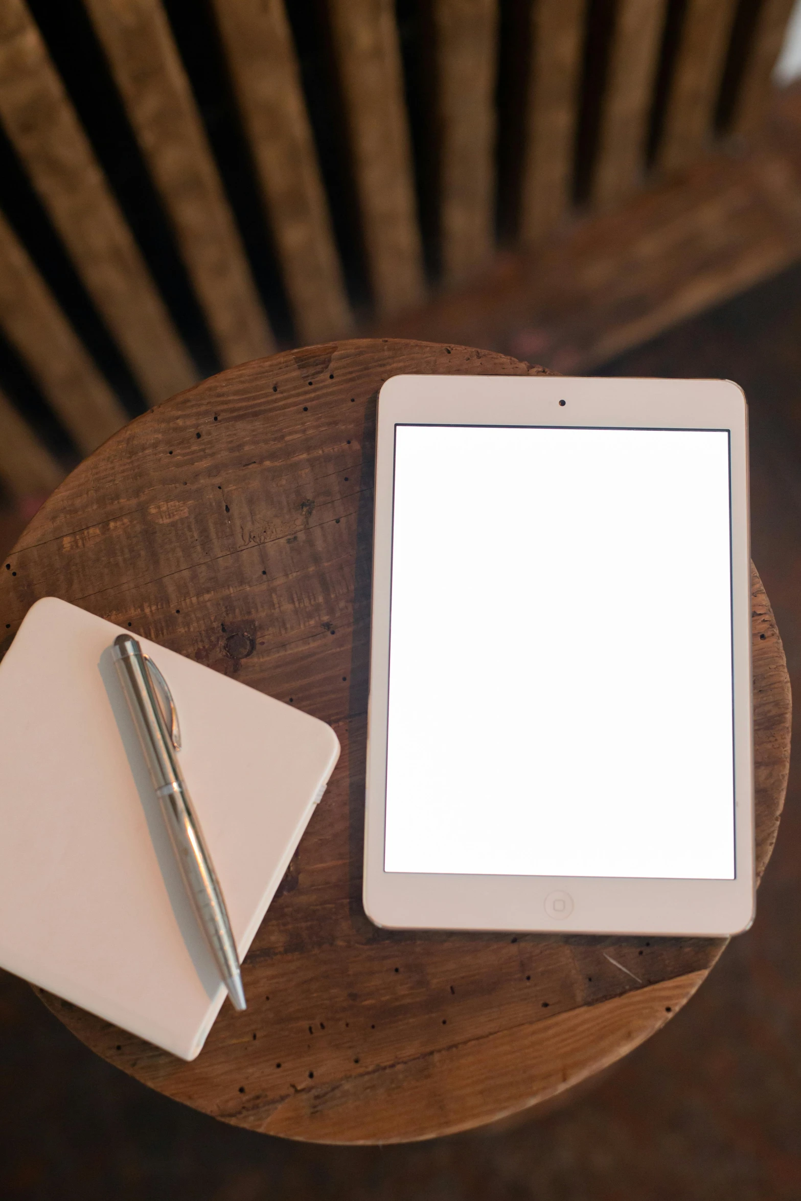 a tablet computer sitting on top of a wooden table, by Robbie Trevino, trending on unsplash, square, whiteboards, round format, brown