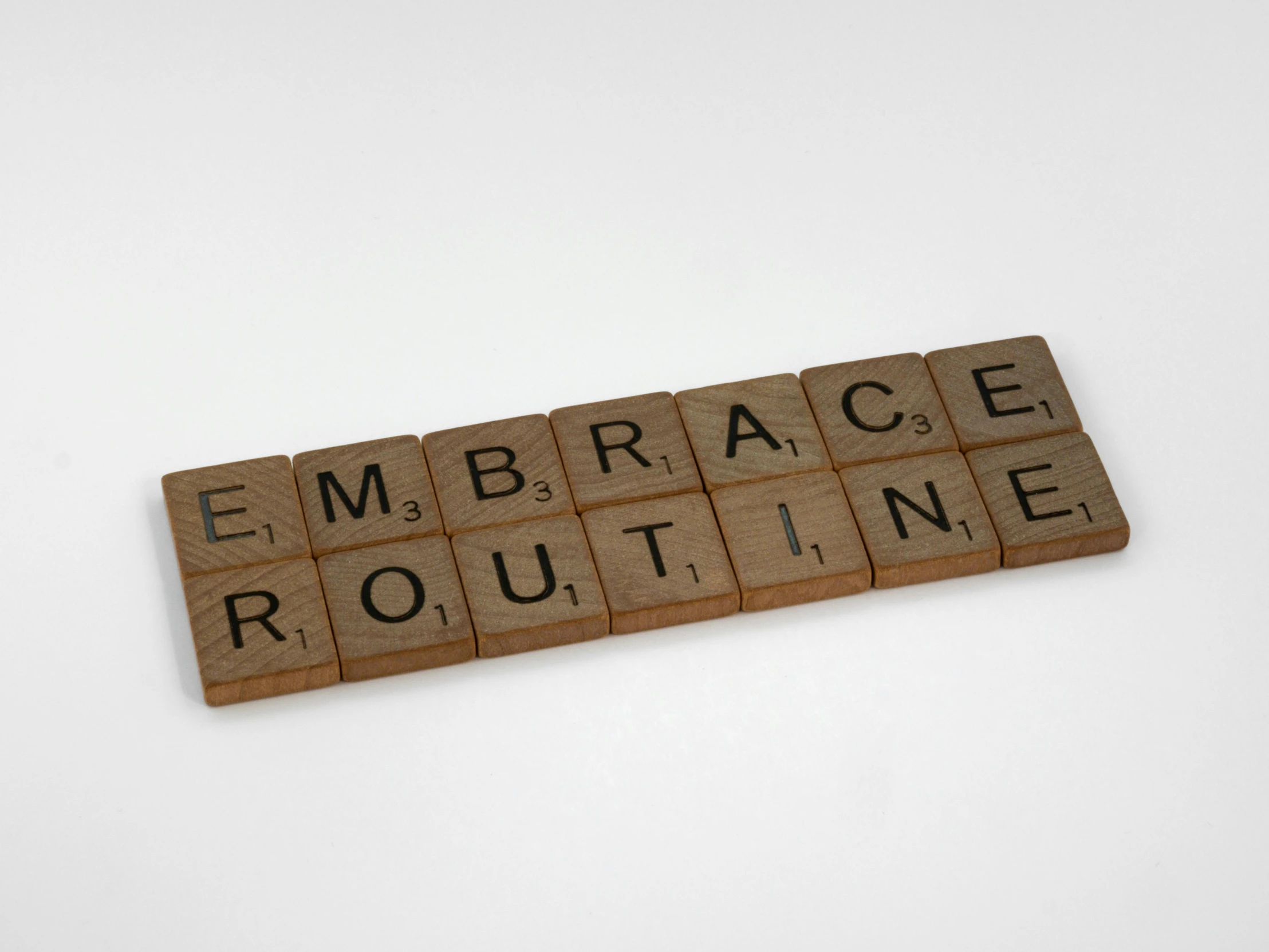 the word emce routine written in scrabble type blocks