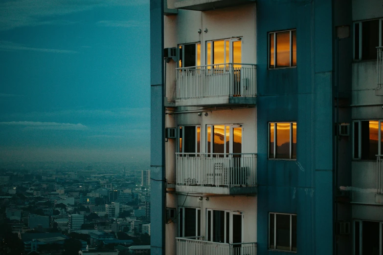 night view of a large building with lights in a window