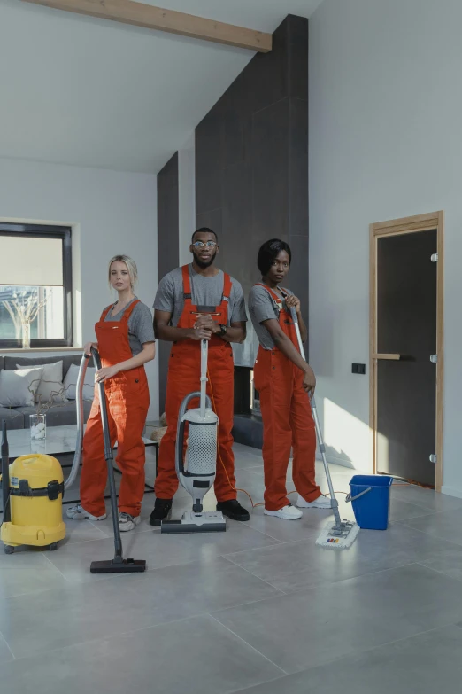 a group of people that are standing in a room, vacuum, grey orange, thumbnail, mkbhd