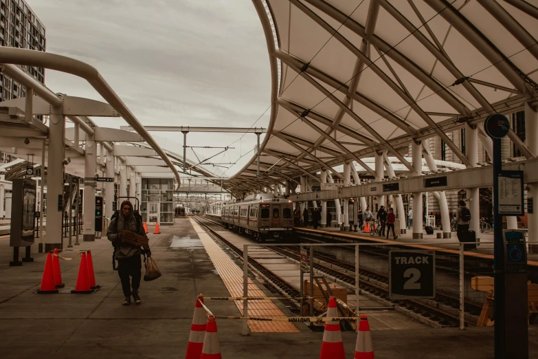 a train station with people walking on the platform, by Ryan Pancoast, pexels contest winner, fan favorite, canopies, from wheaton illinois, ready to model