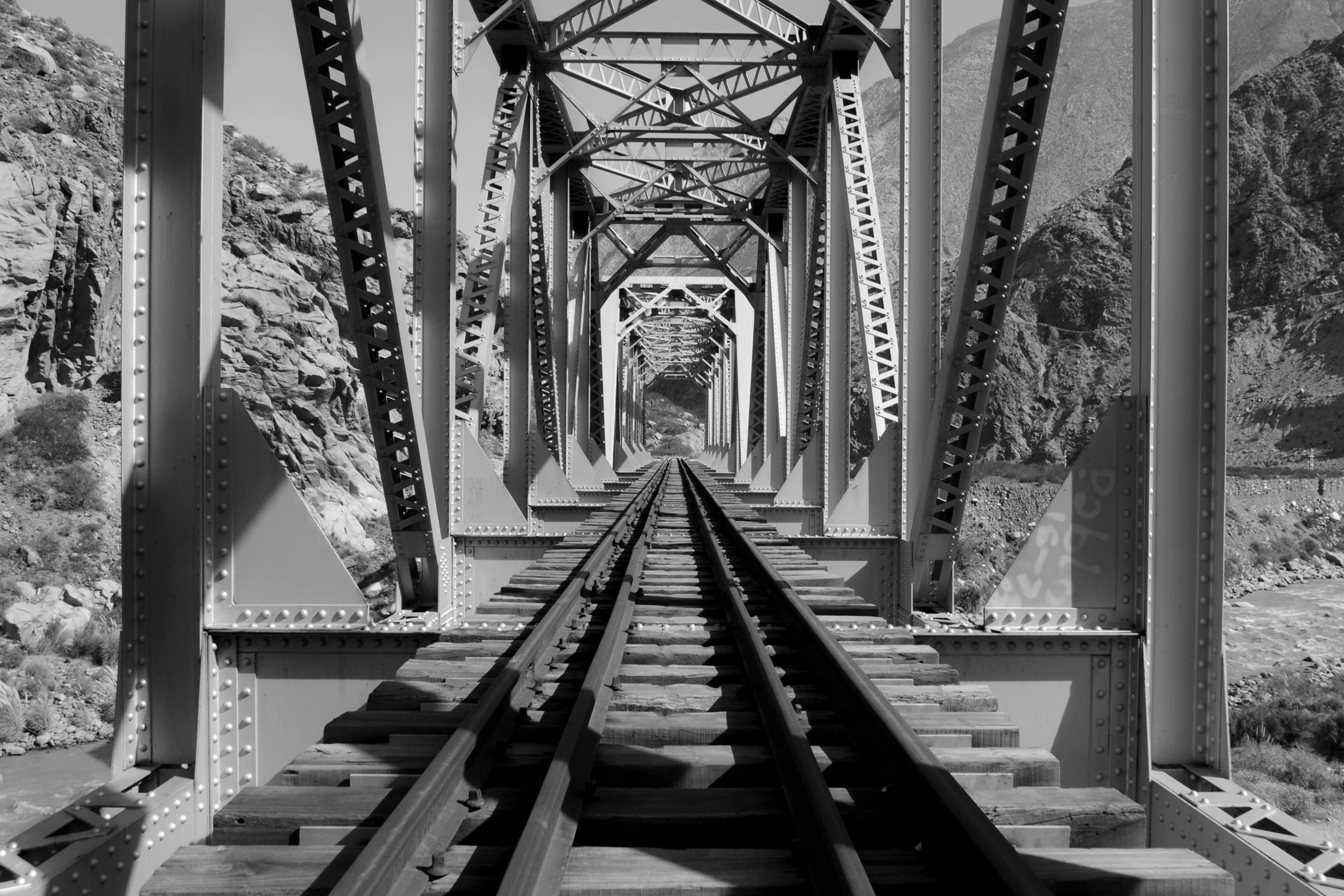 a black and white photo of a train track, a black and white photo, pexels contest winner, op art, old bridge, peaks, infared photography, view from below