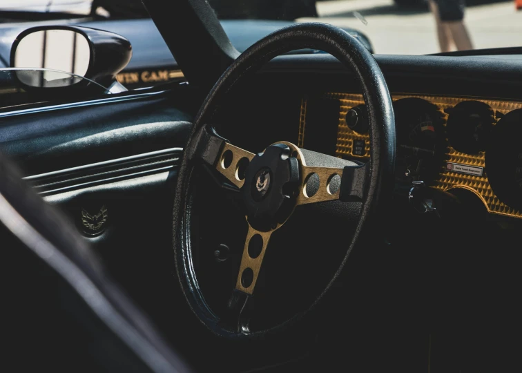 a close up of a steering wheel in a car, by Dan Frazier, pexels contest winner, renaissance, square, black gold color scheme, the car is corvette c2 1969, rally driving photo