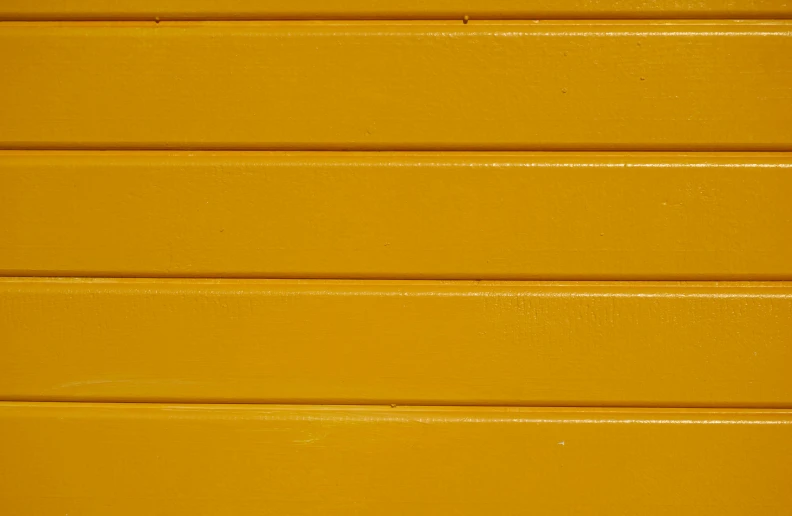 an orange wall with yellow colored wood grain