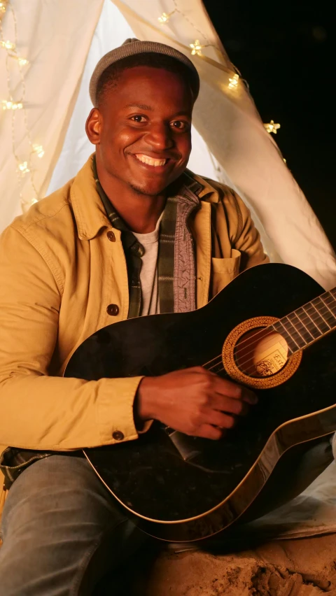 a man that is sitting down with a guitar, pexels, dau-al-set, brown skin man with a giant grin, cast, ( ( dark skin ) ), snapshot