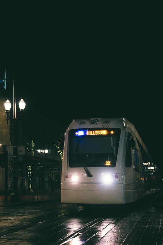 a train traveling down a city street at night, by Washington Allston, unsplash, renaissance, square, cascadia, banner, waiting