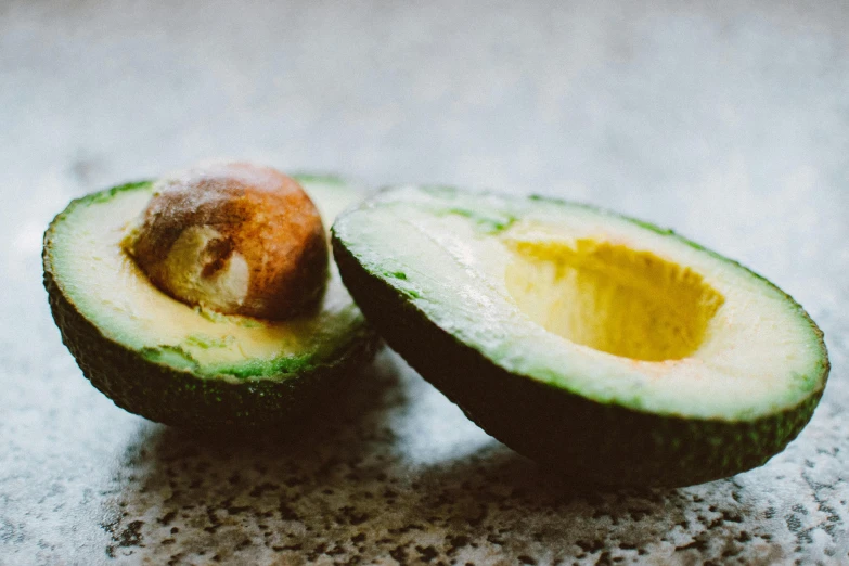 an avocado cut in half on a table, trending on pexels, fan favorite, avatar image, 1970s photo, avocado armchair