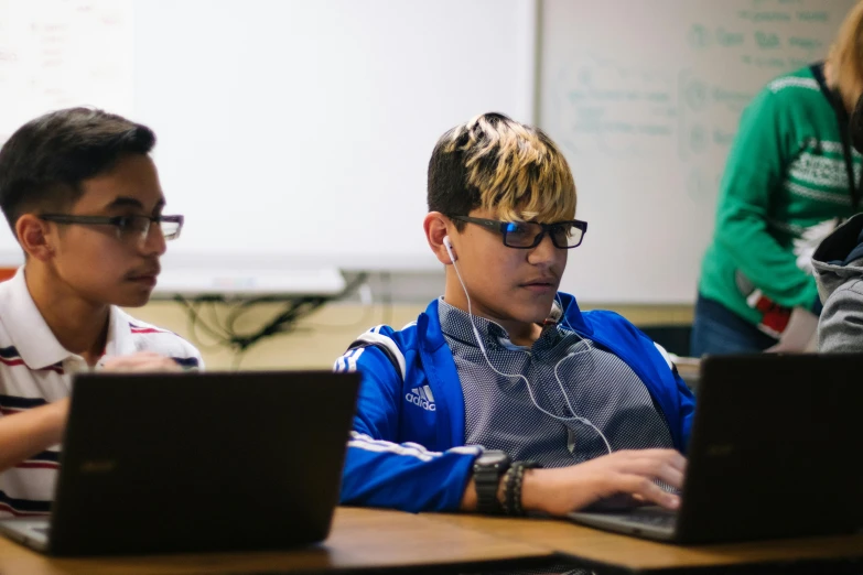 a group of people sitting at a table with laptops, by Byron Galvez, future coder man looking on, working on a laptop at a desk, portrait photo, thumbnail