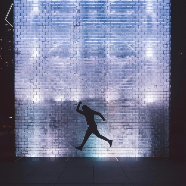 a man that is standing in front of a wall, inspired by Bruce Nauman, pexels contest winner, interactive art, girl running, glass wall, cool lights, unsplash contest winning photo