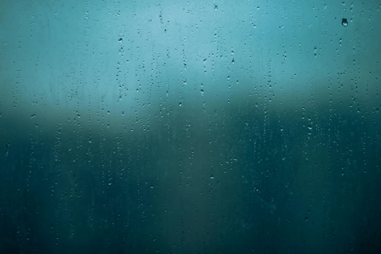 a close up of a window with raindrops on it, an album cover, inspired by Elsa Bleda, unsplash, conceptual art, blue - turquoise fog in the void, mobile wallpaper, medium-shot, looking sad