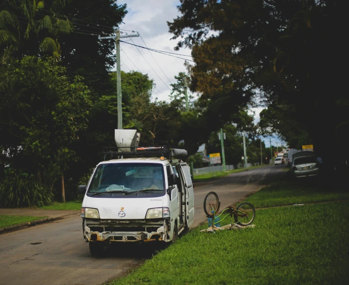 there is a white van that is parked on the side of the street