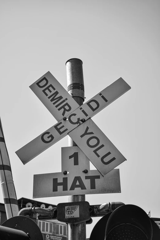 a black and white photo of a railroad crossing, by Dennis Ashbaugh, flickr, cute hats, istanbul, words, dunce