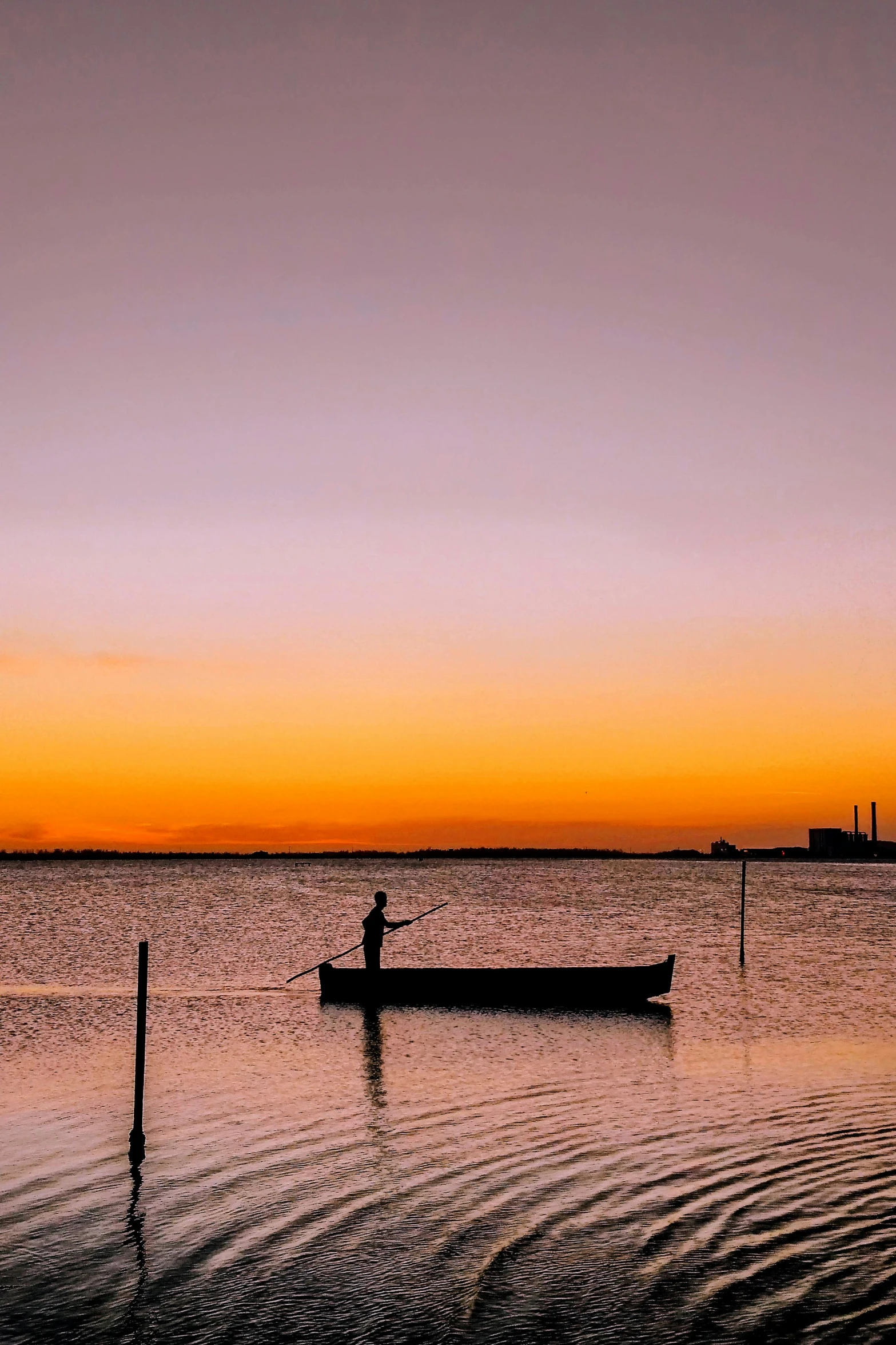 a person in a boat on a body of water, a picture, at sunset, lisbon, islands on horizon, fishing