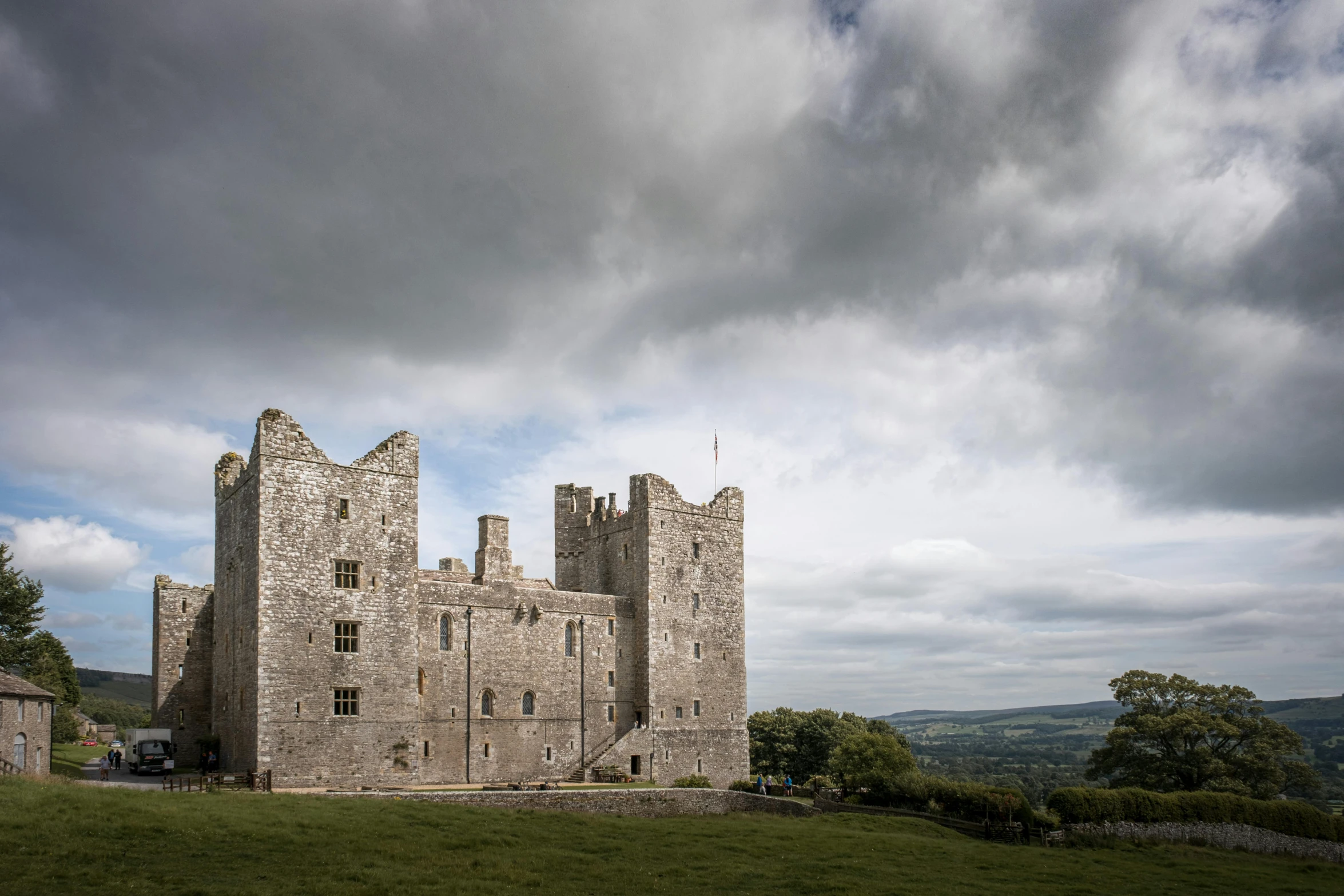 a castle sitting on top of a lush green field, an album cover, by Eamon Everall, pexels contest winner, renaissance, grey, limestone, exterior view, shot on hasselblad