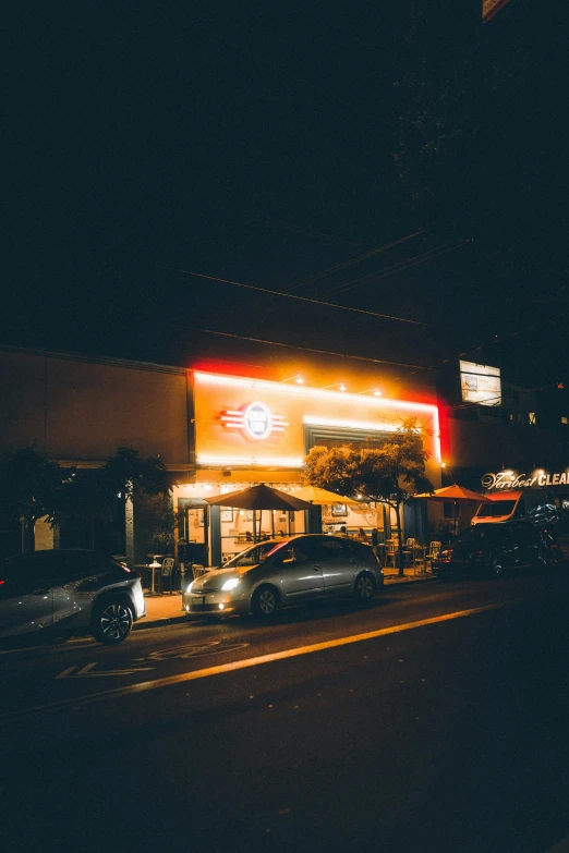 a car is parked in front of a fast food restaurant, unsplash, dimly lit cozy tavern, hollywood standard, wide view, bay area