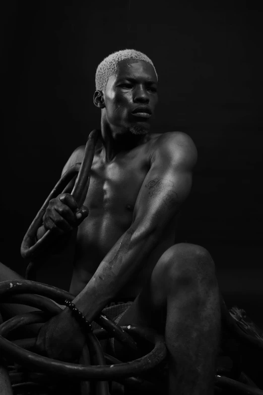 a black and white photo of a man sitting on a motorcycle, an album cover, by Clifford Ellis, pexels contest winner, realism, beautiful male drow, working out, rope, frank ocean