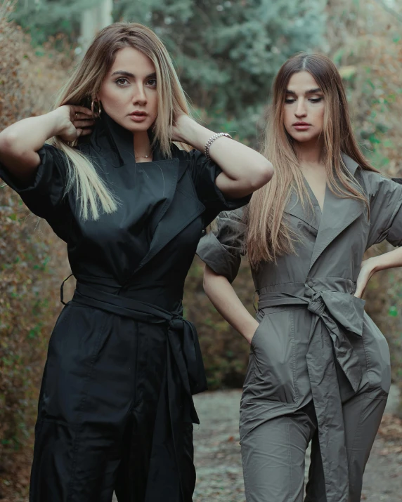 two women standing next to each other on a dirt road, trending on pexels, renaissance, wearing human air force jumpsuit, in gunmetal grey, dasha taran, femalev beauty