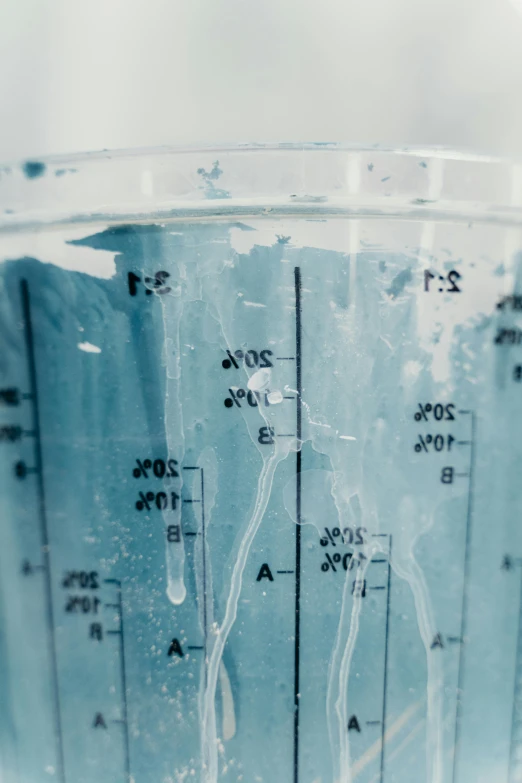 a blender filled with blue liquid sitting on top of a counter, analytical art, wide film still, formulas, cracks, up close image