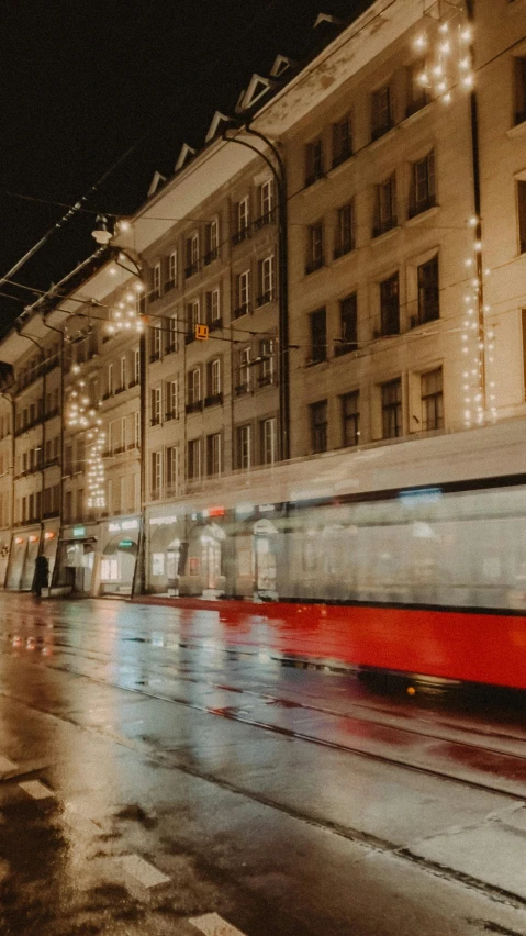 an artistic po of a trolley passing in front of building