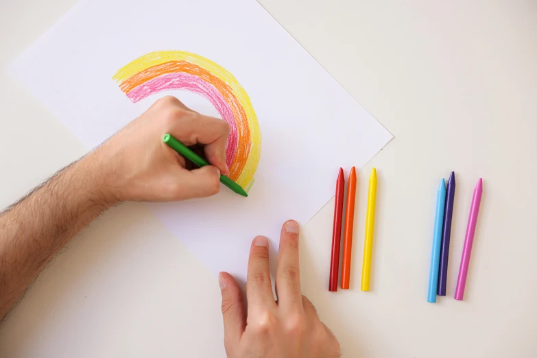 a person drawing with colored pencils on a piece of paper, by Dan Content, pexels contest winner, rainbows, felt tip pen, instagram post, realistic shapes