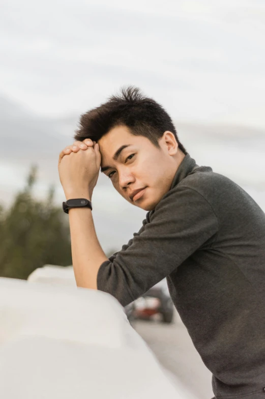 a man leaning against a wall with his hand on his head, inspired by Ryan Yee, professional profile picture, around 1 9 years old, gray sky, avatar image