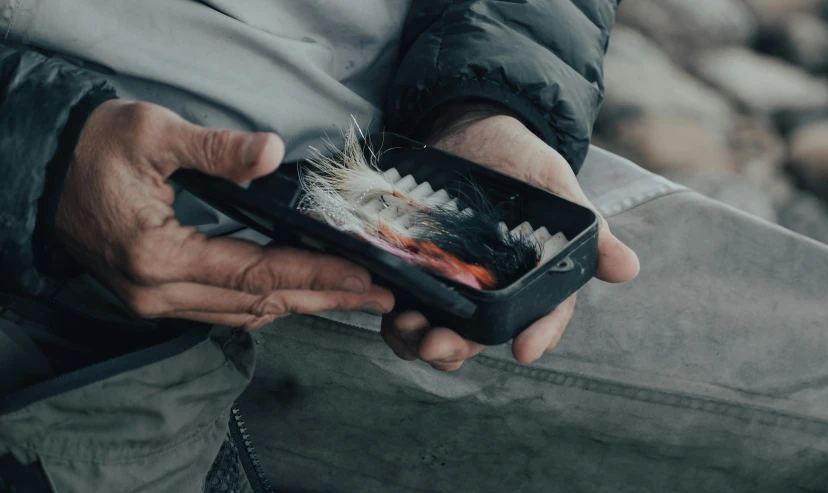 a close up of a person holding a cell phone, by Daniel Lieske, pexels contest winner, fisherman, packshot, rectangle, product picture