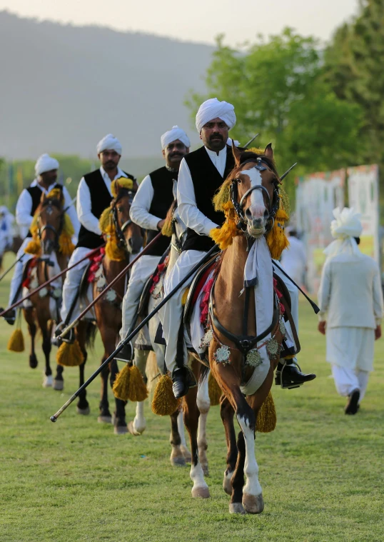 a group of men riding on the backs of horses, pexels contest winner, dau-al-set, wearing a turban, stadium setting, full dress uniform, ( ( theatrical ) )