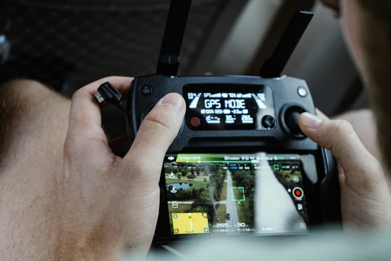 a close up of a person holding a cell phone, uav, cockpit view, view from a news truck, holding controller