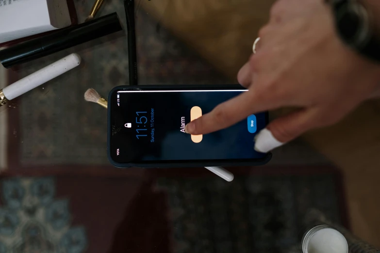 a close up of a person holding a cell phone, taking tobacco snuff, shot on iphone 1 3 pro, placed in a living room, uploaded