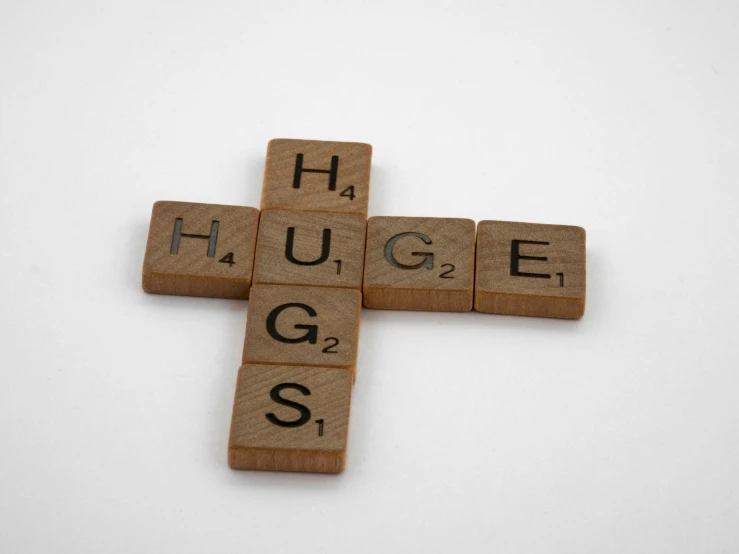 cross made out of scrabble tiles on a white background