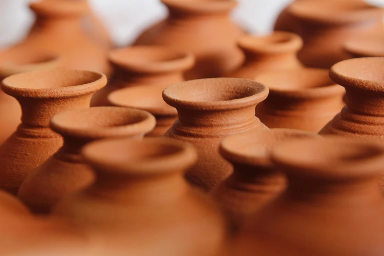 a group of clay pots sitting on top of a table, trending on pexels, neck zoomed in, ochre, profile image, reddish
