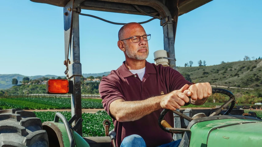 a man driving a tractor in a field, a portrait, by William Berra, unsplash, renaissance, portrait of bald, bay area, in a dark green polo shirt, avatar image