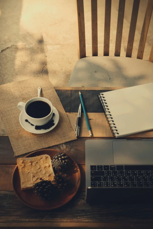 a laptop computer sitting on top of a wooden table, breakfast, sitting on a mocha-colored table, writing a letter, black