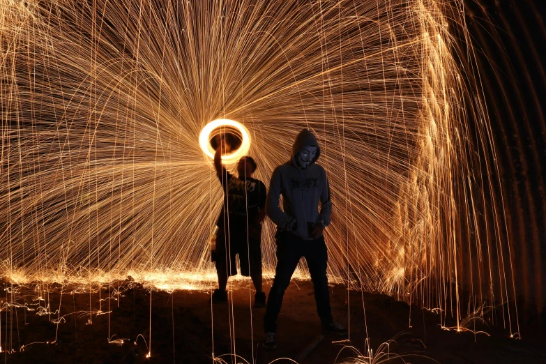 a couple of people standing in front of a fire, a picture, pexels contest winner, art photography, electric arcs, ringflash lighting, the pyro, ilustration