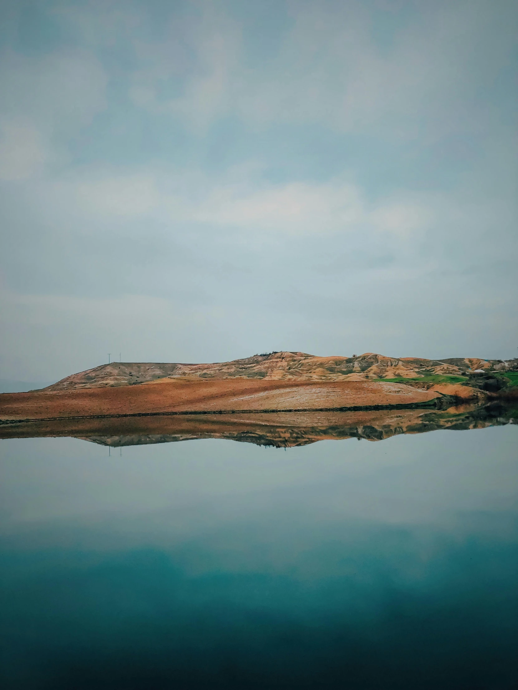 an island on a hill top surrounded by water