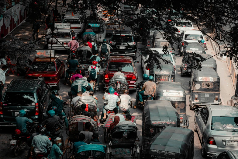 large traffic on a street filled with vehicles and people