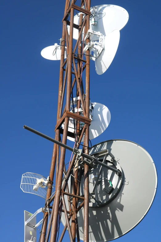 a close up of a cell phone tower with a blue sky in the background, a portrait, flickr, chile, research station, 2006 photograph, winter sun