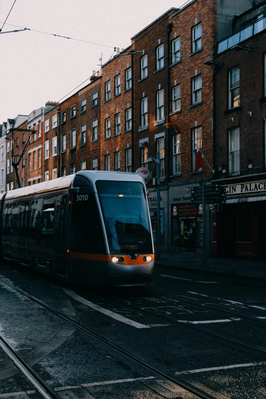 a train going down the tracks next to some buildings