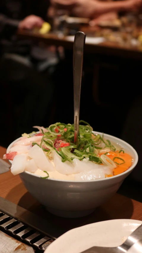 a bowl of food with a large serving spoon stuck in it