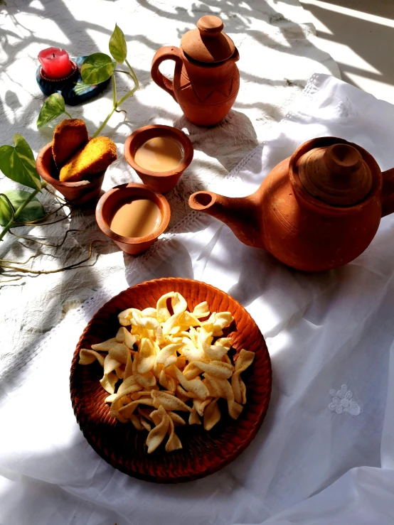 a close up of a plate of food on a table, inspired by Wlodzimierz Tetmajer, dau-al-set, teapots, pasta, brown, high quality product image”