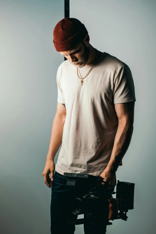 a man standing in front of a camera, unsplash, renaissance, wearing a tee shirt and combats, professionally color graded, musician, dylan cole